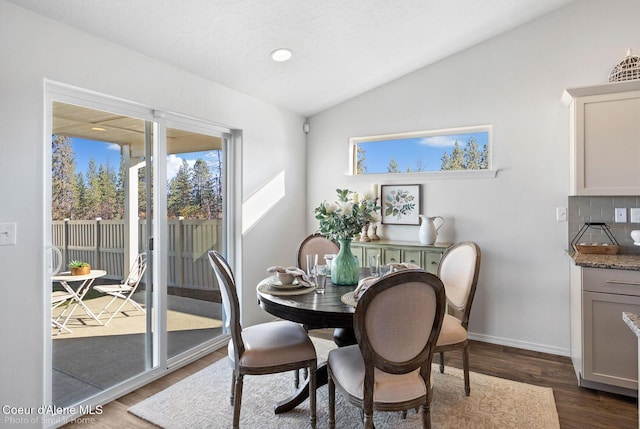 13659 N Apex Way, Hayden, ID 83835 - dining room featuring vaulted ceiling, dark wood-type flooring, and baseboards