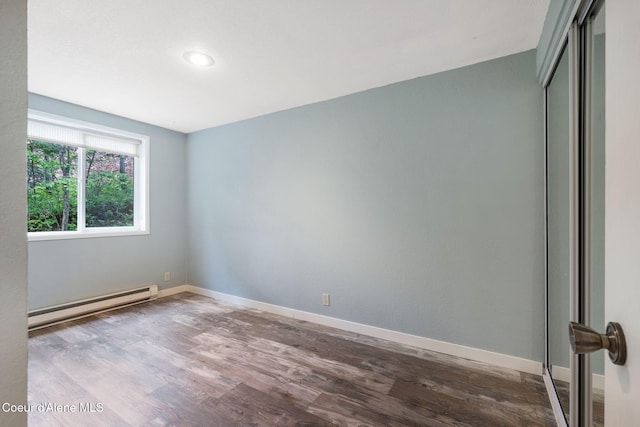 64 Winterbrook Way Unit 101, Sandpoint, ID 83864 - empty room with baseboard heating, wood finished floors, and baseboards