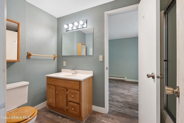 64 Winterbrook Way Unit 101, Sandpoint, ID 83864 - bathroom featuring baseboard heating, wood finished floors, baseboards, a textured wall, and vanity