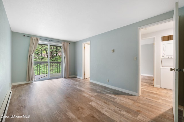 64 Winterbrook Way Unit 101, Sandpoint, ID 83864 - unfurnished room featuring stacked washer / dryer, baseboard heating, wood finished floors, and baseboards