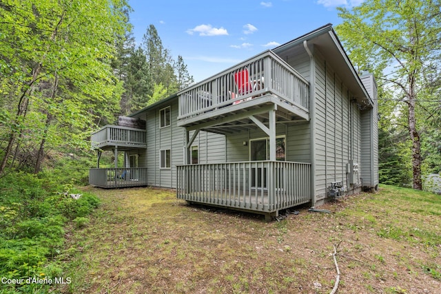64 Winterbrook Way Unit 101, Sandpoint, ID 83864 - rear view of property featuring a wooden deck and a chimney