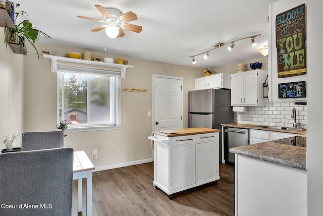 3277 N 10th Pl, Coeur Dalene, ID 83815 - kitchen with a sink, appliances with stainless steel finishes, wood counters, white cabinets, and ceiling fan