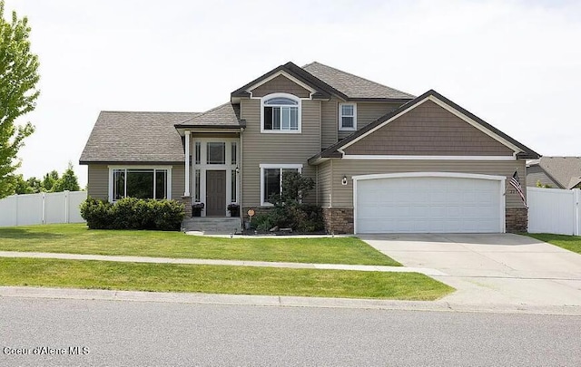 2275 W Freeland Dr, Coeur Dalene, ID 83815 - view of front of home featuring concrete driveway, a garage, stone siding, and roof with shingles