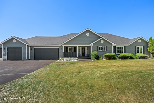 2411 W Diamond Bar Rd, Rathdrum, ID 83858 - ranch-style home with a garage, a porch, asphalt driveway, a front lawn, and roof with shingles
