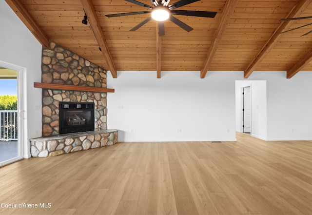 2411 W Diamond Bar Rd, Rathdrum, ID 83858 - unfurnished living room with a wood ceiling with exposed beams, ceiling fan, wood finished floors, a stone fireplace, and high vaulted ceiling