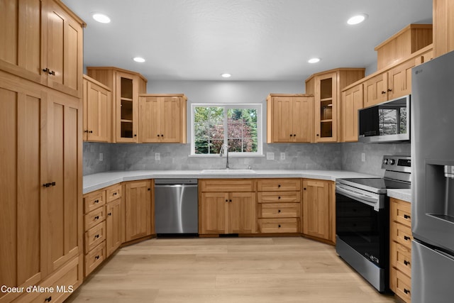 2411 W Diamond Bar Rd, Rathdrum, ID 83858 - kitchen with appliances with stainless steel finishes, light countertops, light wood-style flooring, decorative backsplash, and recessed lighting