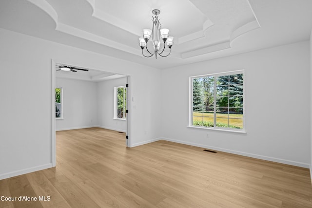 2411 W Diamond Bar Rd, Rathdrum, ID 83858 - unfurnished room featuring a chandelier, a raised ceiling, and light wood-type flooring