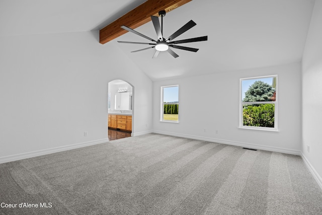 2411 W Diamond Bar Rd, Rathdrum, ID 83858 - empty room featuring beamed ceiling, a ceiling fan, carpet, arched walkways, and high vaulted ceiling