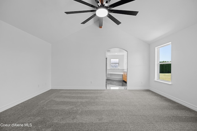 2411 W Diamond Bar Rd, Rathdrum, ID 83858 - unfurnished room with arched walkways, carpet flooring, a ceiling fan, healthy amount of natural light, and lofted ceiling