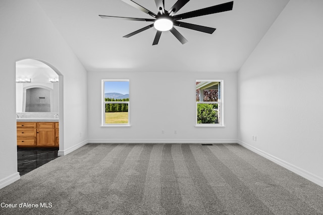 2411 W Diamond Bar Rd, Rathdrum, ID 83858 - unfurnished bedroom featuring lofted ceiling, carpet flooring, multiple windows, connected bathroom, and ceiling fan