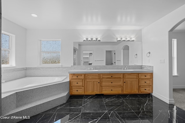 2411 W Diamond Bar Rd, Rathdrum, ID 83858 - bathroom with double vanity, a garden tub, marble finish flooring, and recessed lighting