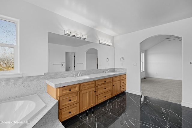 2411 W Diamond Bar Rd, Rathdrum, ID 83858 - bathroom with double vanity, marble tiled flooring, and a bathtub