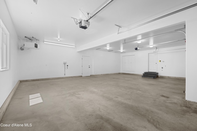 2411 W Diamond Bar Rd, Rathdrum, ID 83858 - garage featuring a garage door opener and baseboards
