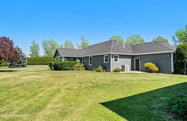 2411 W Diamond Bar Rd, Rathdrum, ID 83858 - back of house featuring a lawn and a shingled roof