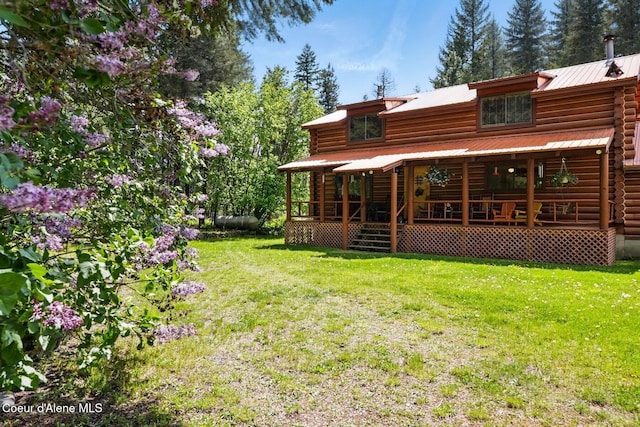 1180 Mountain View Rd, Clark Fork, ID 83811 - rear view of property with log siding, a lawn, and metal roof
