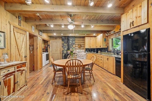 1180 Mountain View Rd, Clark Fork, ID 83811 - dining room with wood ceiling with exposed beams, light wood-type flooring, ceiling fan, and wooden walls