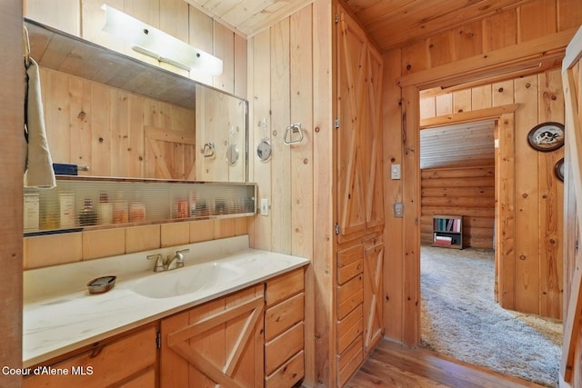 1180 Mountain View Rd, Clark Fork, ID 83811 - bathroom featuring wooden ceiling, vanity, wooden walls, and wood finished floors