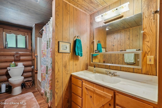 1180 Mountain View Rd, Clark Fork, ID 83811 - full bathroom featuring wooden ceiling, toilet, wood finished floors, vanity, and log walls