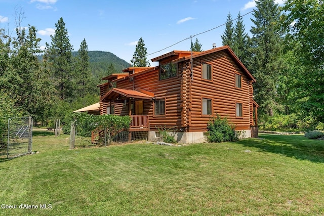 1180 Mountain View Rd, Clark Fork, ID 83811 - rear view of property featuring log exterior, a lawn, and a mountain view