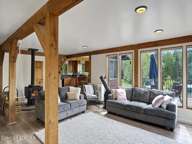 1155 Gold Creek Ridge Rd, Sandpoint, ID 83864 - living area featuring wood finished floors, a wood stove, and lofted ceiling