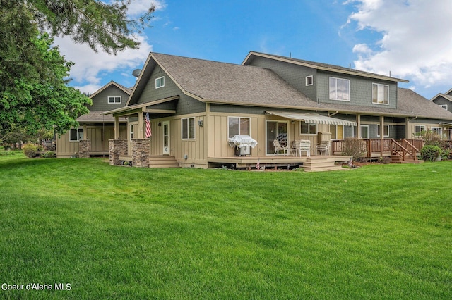 49-C Chardonnay Dr, Blanchard, ID 83804 - rear view of house featuring board and batten siding, a lawn, roof with shingles, and a wooden deck