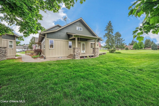 49-C Chardonnay Dr, Blanchard, ID 83804 - back of house with a yard, covered porch, and board and batten siding