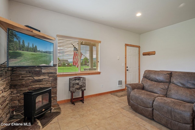 49-C Chardonnay Dr, Blanchard, ID 83804 - living room featuring a wood stove, light tile patterned floors, recessed lighting, and baseboards
