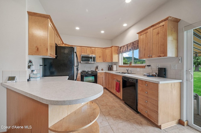 49-C Chardonnay Dr, Blanchard, ID 83804 - kitchen featuring black appliances, a sink, a peninsula, tasteful backsplash, and recessed lighting