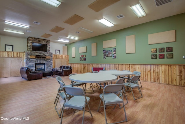 49-C Chardonnay Dr, Blanchard, ID 83804 - dining room featuring a fireplace, light wood-style flooring, wainscoting, and wooden walls