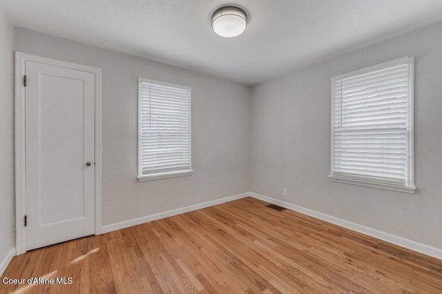 1415 N 2nd St, Coeur Dalene, ID 83814 - spare room with light wood-style floors, baseboards, and plenty of natural light
