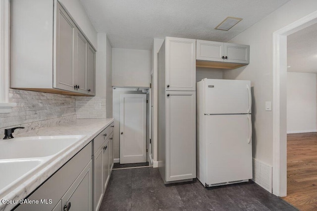 1415 N 2nd St, Coeur Dalene, ID 83814 - kitchen with freestanding refrigerator, decorative backsplash, a sink, light countertops, and gray cabinets