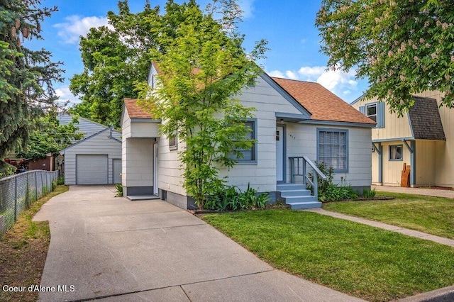 1415 N 2nd St, Coeur Dalene, ID 83814 - view of front of property featuring driveway, a garage, an outdoor structure, and a shingled roof