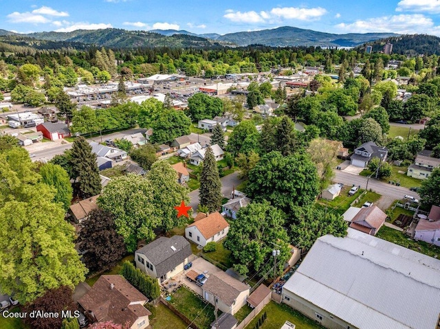 1415 N 2nd St, Coeur Dalene, ID 83814 - aerial overview of property's location featuring mountains, nearby suburban area, and a heavily wooded area