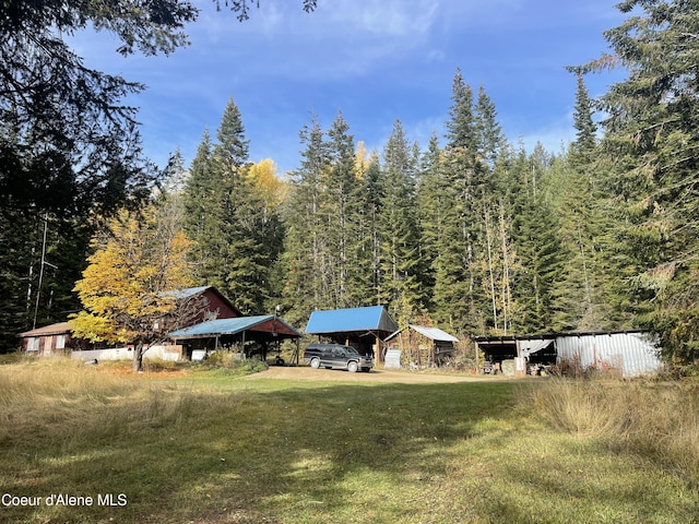 1728 Dry Creek Rd, Clark Fork, ID 83811 - view of grassy yard with a forest view and a detached carport
