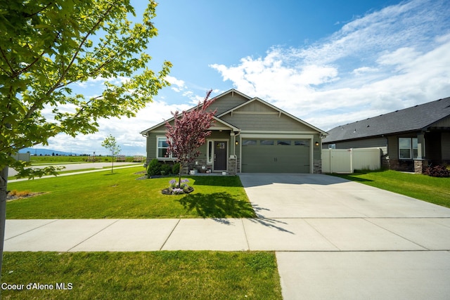 13311 N Loveland Way, Hayden, ID 83835 - craftsman-style home with stone siding, driveway, and an attached garage