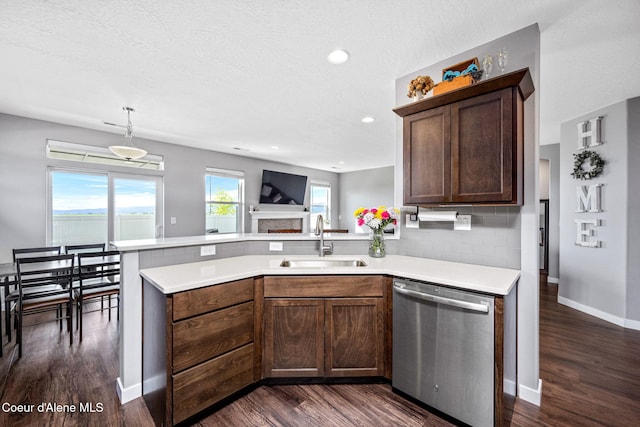 13311 N Loveland Way, Hayden, ID 83835 - kitchen featuring stainless steel dishwasher, a sink, light countertops, a peninsula, and dark wood finished floors