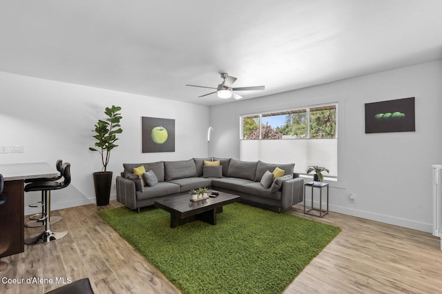 2840 W Masters Dr, Coeur Dalene, ID 83815 - living room with light wood finished floors, ceiling fan, and baseboards