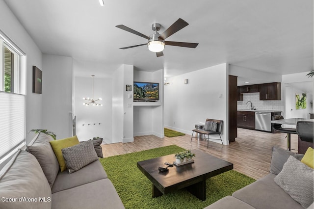 2840 W Masters Dr, Coeur Dalene, ID 83815 - living area featuring light wood-style flooring, a chandelier, a ceiling fan, and baseboards