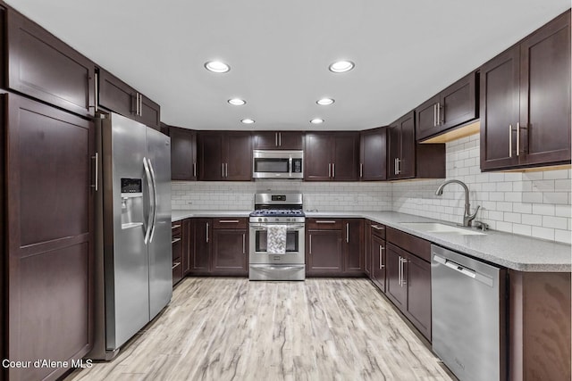 2840 W Masters Dr, Coeur Dalene, ID 83815 - kitchen featuring appliances with stainless steel finishes, a sink, tasteful backsplash, light countertops, and recessed lighting
