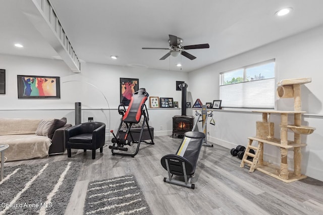 2840 W Masters Dr, Coeur Dalene, ID 83815 - workout area featuring wood finished floors, a ceiling fan, recessed lighting, a wood stove, and baseboards