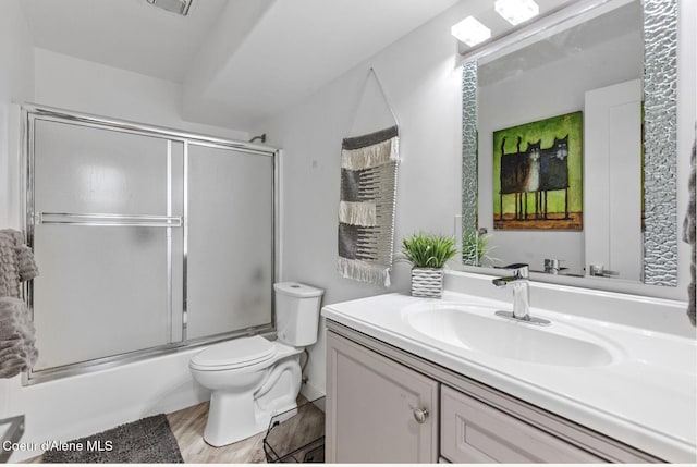 2840 W Masters Dr, Coeur Dalene, ID 83815 - bathroom with vanity, toilet, combined bath / shower with glass door, and wood finished floors