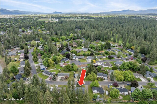 2840 W Masters Dr, Coeur Dalene, ID 83815 - aerial view of property's location with a mountain backdrop and a forest