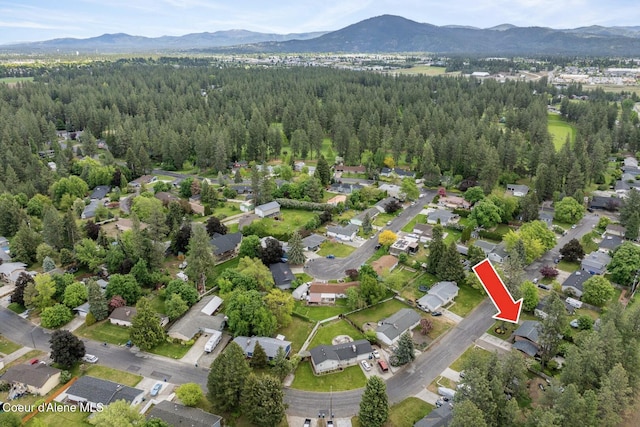 2840 W Masters Dr, Coeur Dalene, ID 83815 - view of property location with a mountainous background, a forest, and nearby suburban area