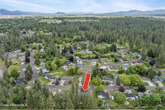 2840 W Masters Dr, Coeur Dalene, ID 83815 - aerial view of property and surrounding area featuring a mountain backdrop and a heavily wooded area