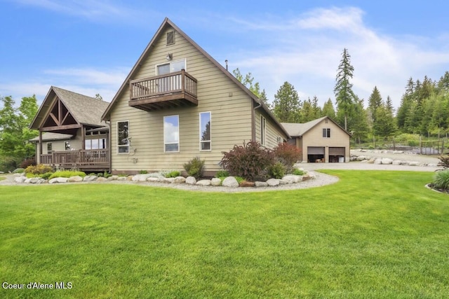 558 Grouse Hill Rd, Bonners Ferry, ID 83805 - back of property with a balcony, a yard, a garage, and driveway