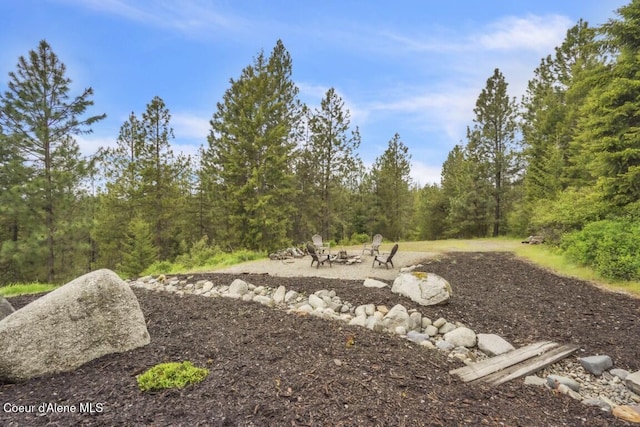 558 Grouse Hill Rd, Bonners Ferry, ID 83805 - view of yard with a fire pit and a forest view