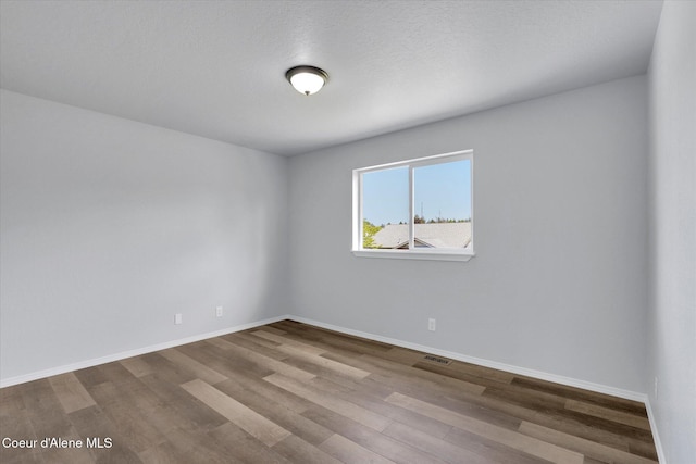 2230 N Methow Ct, Post Falls, ID 83854 - unfurnished room featuring wood finished floors and baseboards