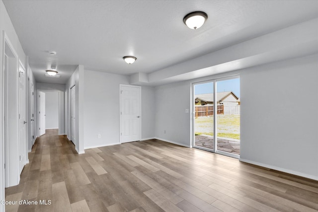 2230 N Methow Ct, Post Falls, ID 83854 - unfurnished bedroom with access to exterior, wood finished floors, and baseboards