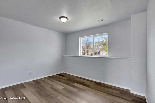 2230 N Methow Ct, Post Falls, ID 83854 - empty room featuring wood finished floors, baseboards, and a textured ceiling
