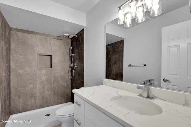 2230 N Methow Ct, Post Falls, ID 83854 - bathroom featuring vanity, toilet, a chandelier, and a tile shower